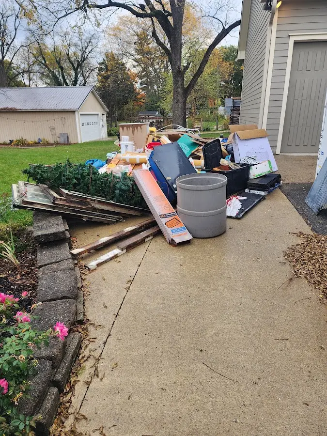 Dumpster being loaded with debris for Roofing Dumpster Rental in Mattoon